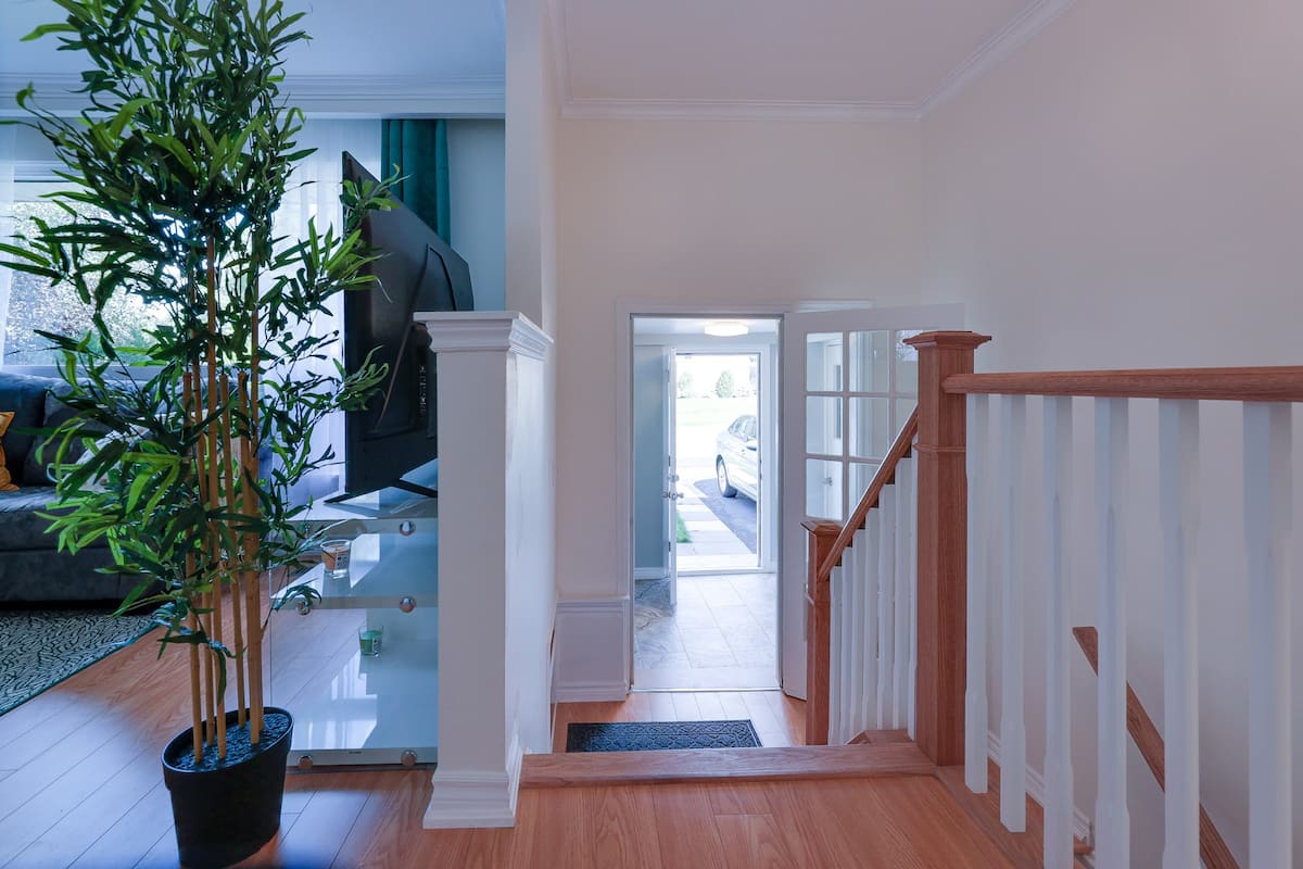 Wood staircase leading toward the front entrance